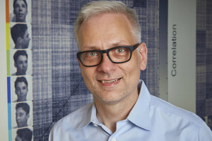 Winrich Freiwald in a blue shirt and glasses